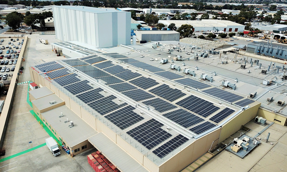 Bird's eye view of a facility with solar panels on the roof