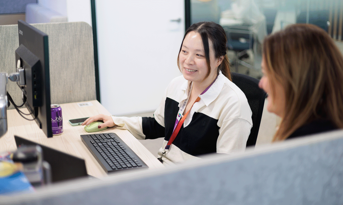 Employees working together at a computer