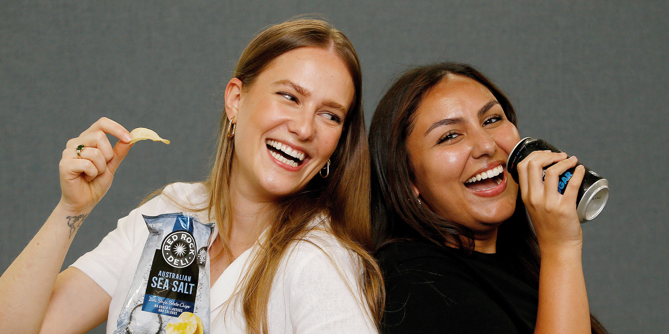 Women holding Red Rock Deli chips and Pepsi Zero Sugar can